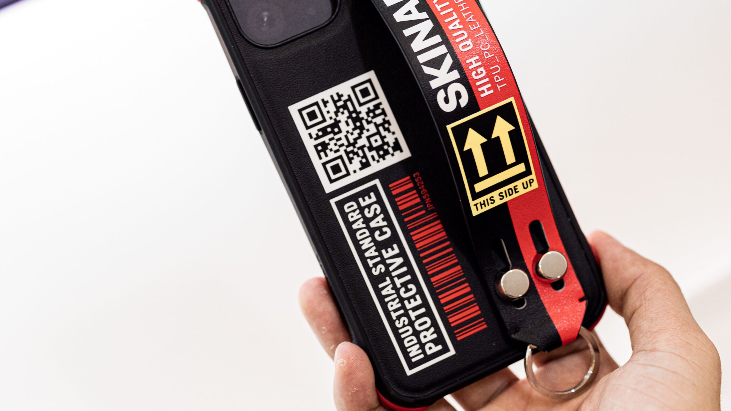 A person engaging consumers with a phone case featuring a QR code.