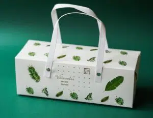 An eco-friendly white paper bag adorned with green leaves.